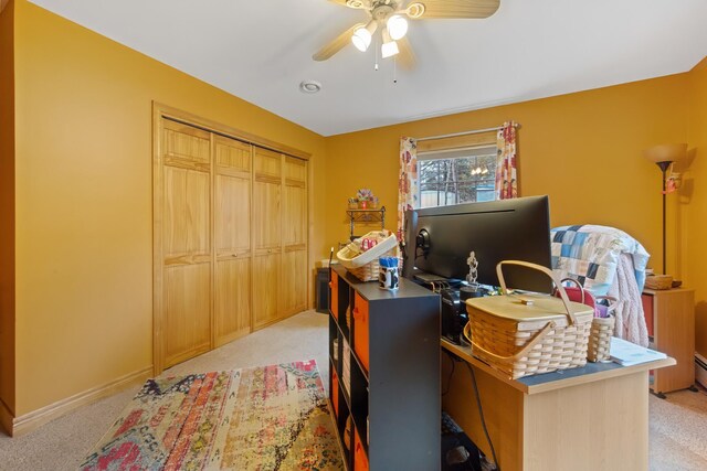 home office featuring light carpet, ceiling fan, and baseboards