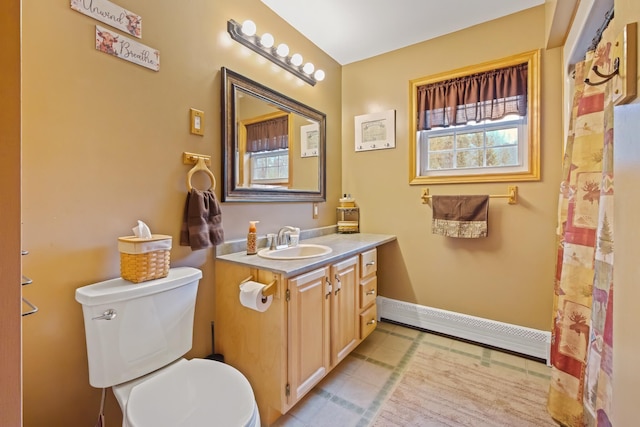 bathroom featuring baseboards, toilet, baseboard heating, vanity, and tile patterned flooring