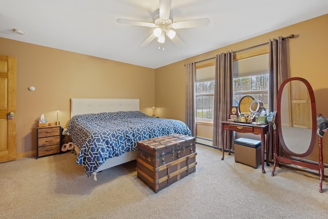 carpeted bedroom with ceiling fan and baseboards