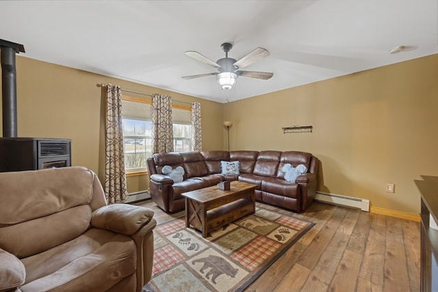 living room featuring light wood-style floors, ceiling fan, a baseboard heating unit, a baseboard radiator, and baseboards