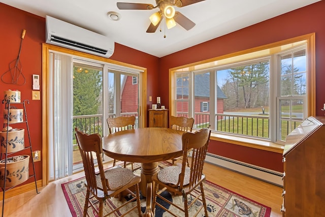 dining room with a wealth of natural light, an AC wall unit, a baseboard heating unit, and ceiling fan