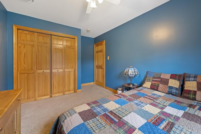 bedroom featuring light carpet, a closet, baseboards, and a ceiling fan