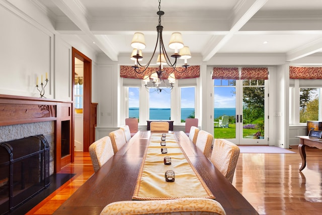 dining area featuring a decorative wall, light wood finished floors, and a notable chandelier