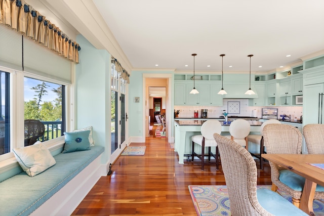 living room with recessed lighting, wood finished floors, and baseboards