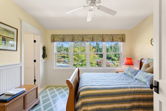 bedroom with wainscoting and ceiling fan