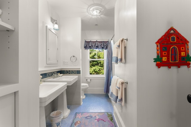 full bath with toilet and a sink