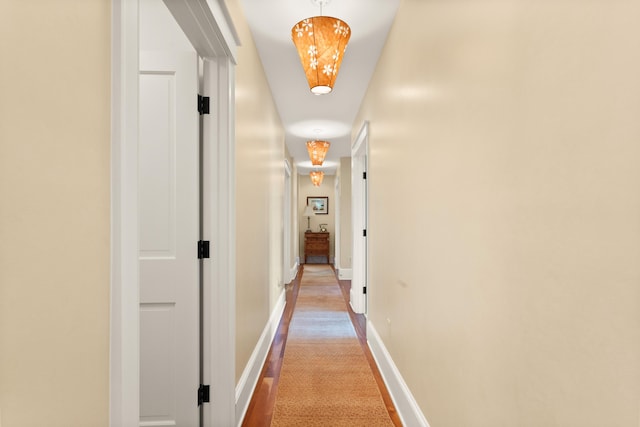 corridor featuring carpet and baseboards