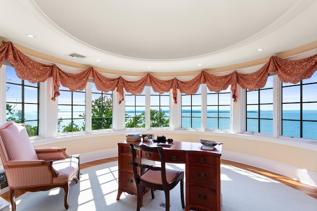 office area with a healthy amount of sunlight, visible vents, and a water view