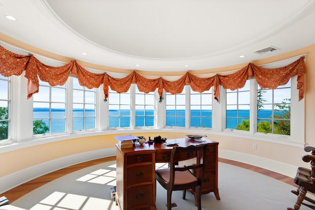 sunroom / solarium featuring plenty of natural light, a water view, and visible vents