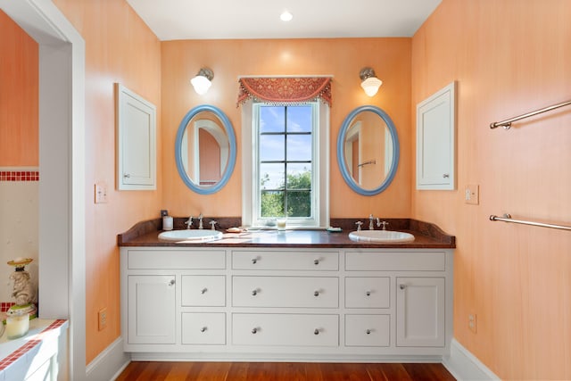 bathroom featuring a sink and double vanity