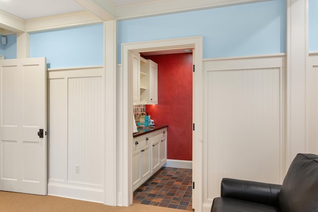 interior space featuring baseboards and ornamental molding