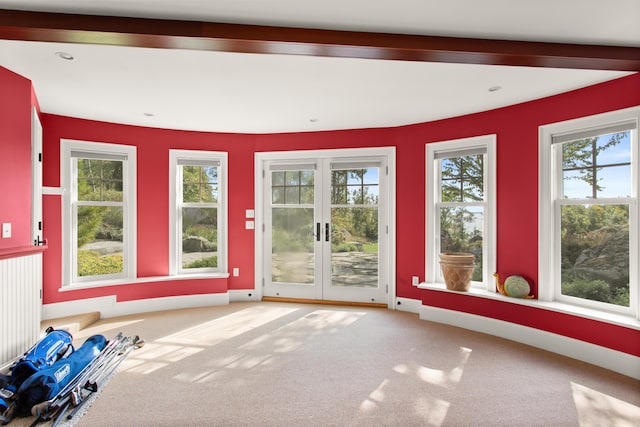 doorway featuring beamed ceiling, carpet floors, baseboards, and french doors