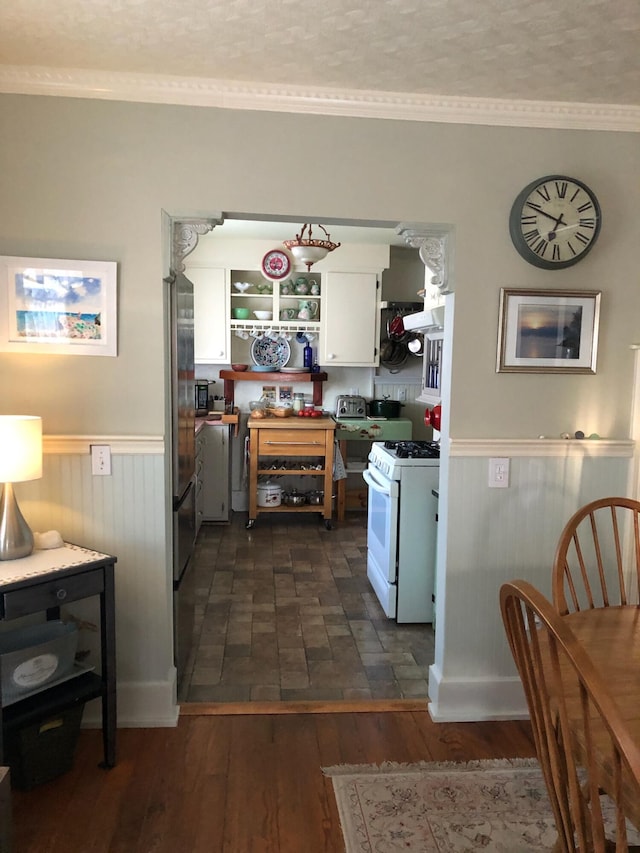 57 Salmond St, Belfast, ME 04915 - kitchen featuring white range with gas cooktop, open shelves, white cabinetry, wainscoting, and crown molding