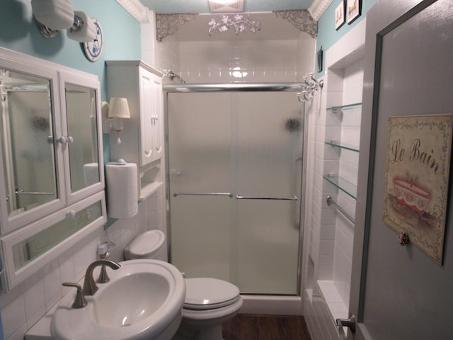 57 Salmond St, Belfast, ME 04915 - bathroom featuring a sink, toilet, a shower stall, tile walls, and backsplash