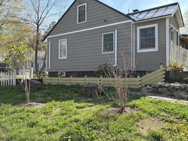 57 Salmond St, Belfast, ME 04915 - view of property exterior with fence, a standing seam roof, and metal roof