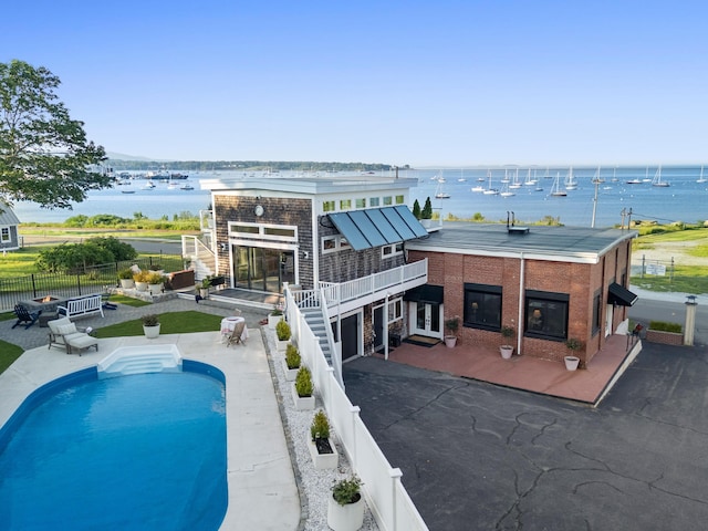 21 Atlantic St, Rockland, ME 04841 - view of swimming pool with a fenced backyard, a patio area, a water view, and stairs