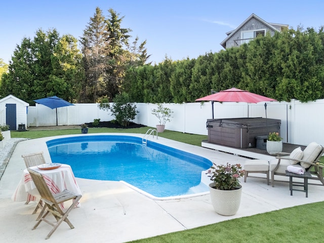 21 Atlantic St, Rockland, ME 04841 - view of swimming pool with a hot tub, a patio, a fenced backyard, and a shed