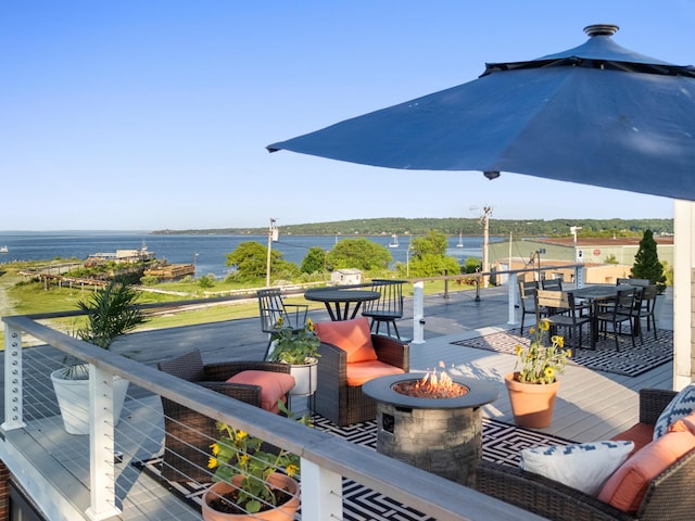 21 Atlantic St, Rockland, ME 04841 - deck with outdoor dining space, an outdoor fire pit, and a water view