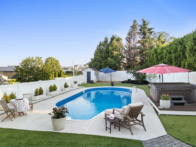 21 Atlantic St, Rockland, ME 04841 - view of swimming pool featuring a hot tub, a fenced backyard, a patio, and a shed