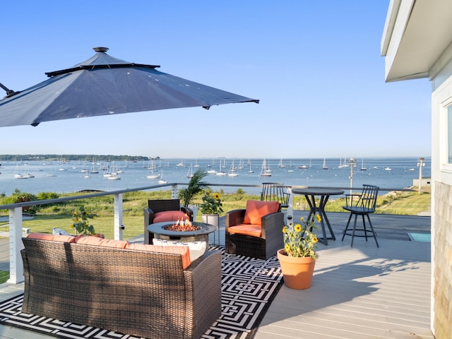 21 Atlantic St, Rockland, ME 04841 - wooden terrace featuring a water view and an outdoor living space with a fire pit