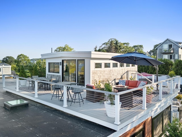 21 Atlantic St, Rockland, ME 04841 - rear view of house featuring outdoor dining space, a deck, and outdoor lounge area