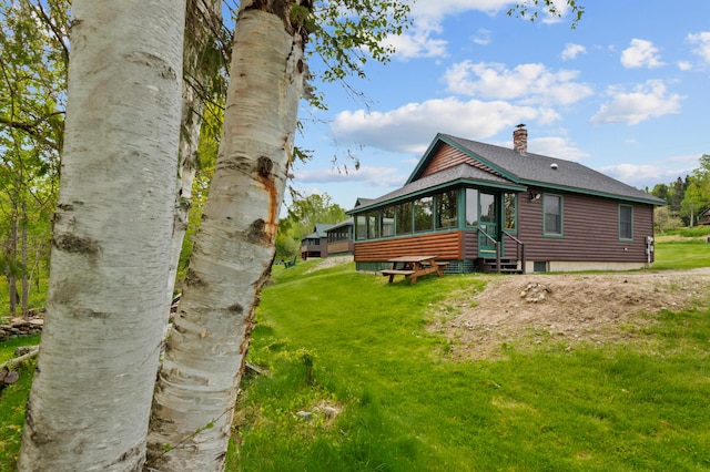 747 S Shore Dr Unit 6, Rangeley Plt, ME 04970 - rear view of property featuring log veneer siding, a sunroom, a chimney, a shingled roof, and a lawn