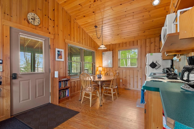 747 S Shore Dr Unit 6, Rangeley Plt, ME 04970 - dining space featuring vaulted ceiling, light wood-type flooring, wood walls, baseboards, and wood ceiling