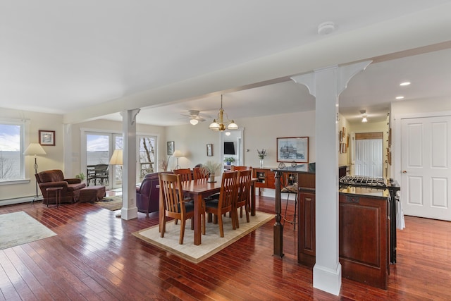dining room featuring recessed lighting, dark wood finished floors, a healthy amount of sunlight, and ornate columns