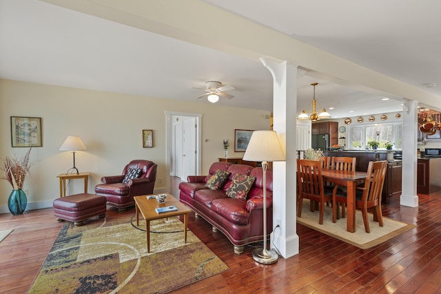 living area featuring ceiling fan with notable chandelier, recessed lighting, ornate columns, and wood-type flooring