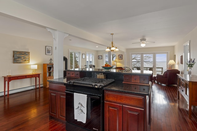 kitchen featuring baseboard heating, black range with gas stovetop, dark brown cabinets, open floor plan, and dark wood-style flooring