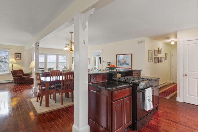 kitchen featuring plenty of natural light, black gas stove, reddish brown cabinets, and decorative columns