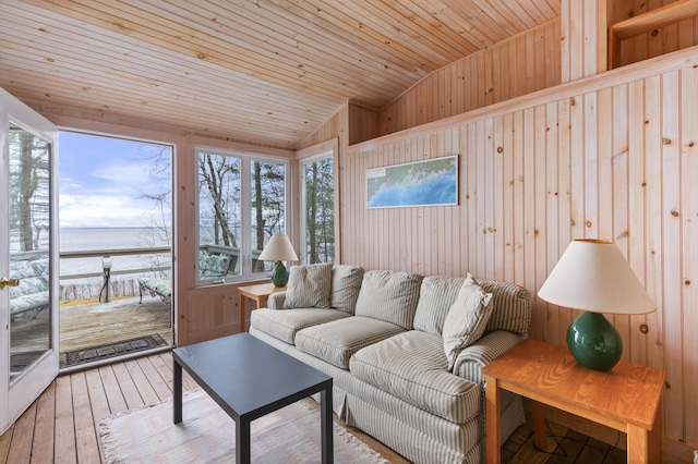 living room featuring lofted ceiling, hardwood / wood-style floors, a water view, and wood ceiling