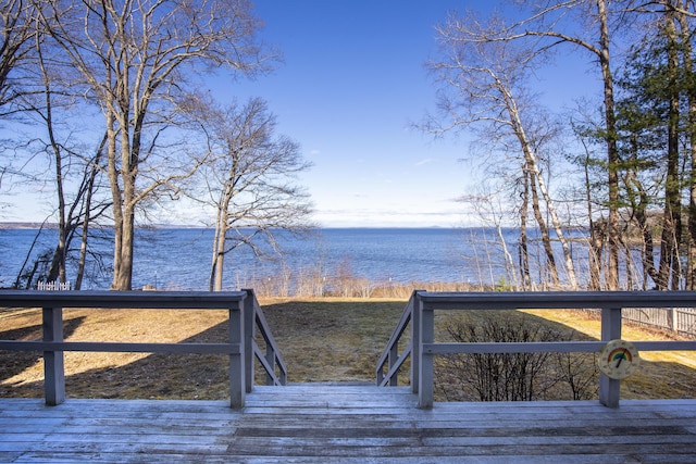 wooden deck featuring a water view