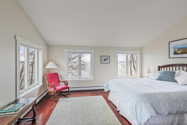 bedroom with a baseboard heating unit, vaulted ceiling, and dark wood-style floors