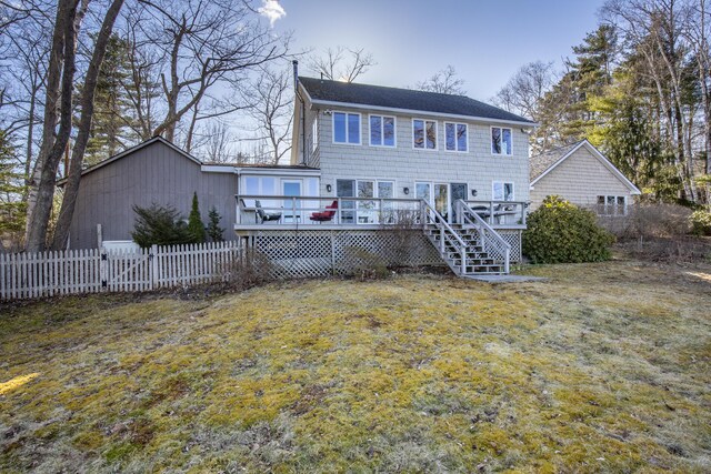 rear view of house featuring a wooden deck, fence, a yard, and stairs