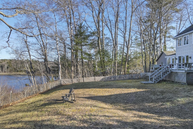 view of yard with a fenced backyard, stairway, and a deck