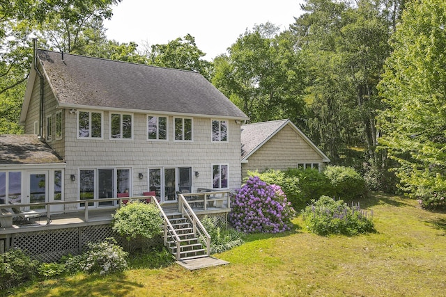 33 Crest St, Northport, ME 04849 - back of house with a shingled roof, a wooden deck, and a lawn