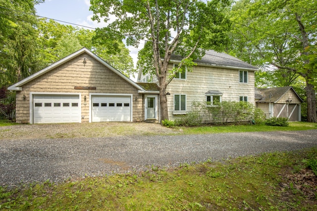 33 Crest St, Northport, ME 04849 - view of front facade featuring a garage, driveway, and roof with shingles