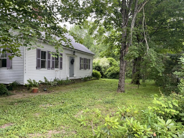 67 Elm St, Newfield, ME 04095 - view of front facade with a metal roof and a front lawn