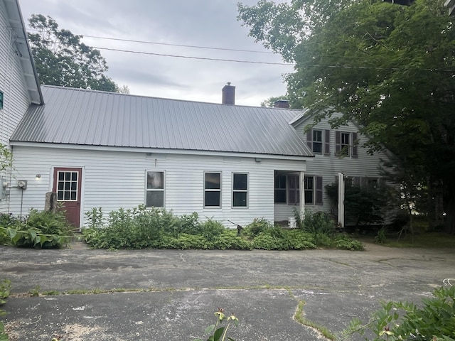 67 Elm St, Newfield, ME 04095 - back of property with a chimney and a metal roof