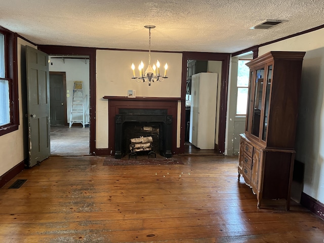 67 Elm St, Newfield, ME 04095 - unfurnished living room with a textured ceiling, a chandelier, hardwood / wood-style floors, and a fireplace