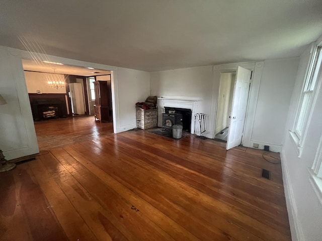 67 Elm St, Newfield, ME 04095 - unfurnished living room with a fireplace, hardwood / wood-style floors, and a chandelier