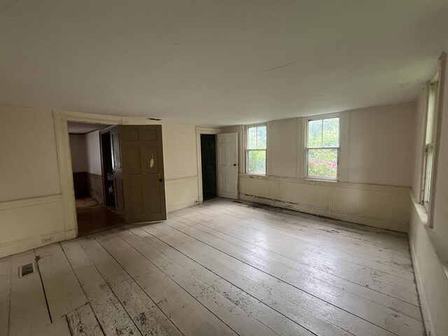 67 Elm St, Newfield, ME 04095 - spare room with light wood-type flooring and a wainscoted wall