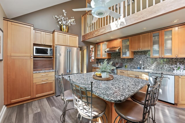 56 Old Kings Hwy, Ogunquit, ME 03907 - kitchen featuring light wood-style floors, tasteful backsplash, a breakfast bar, under cabinet range hood, and stainless steel appliances