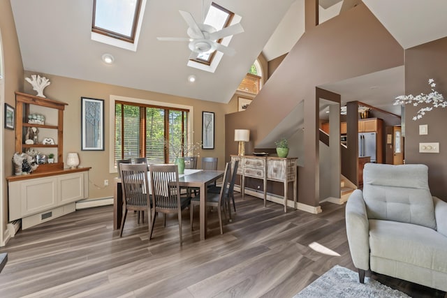 56 Old Kings Hwy, Ogunquit, ME 03907 - dining room with baseboards, baseboard heating, wood finished floors, a skylight, and high vaulted ceiling