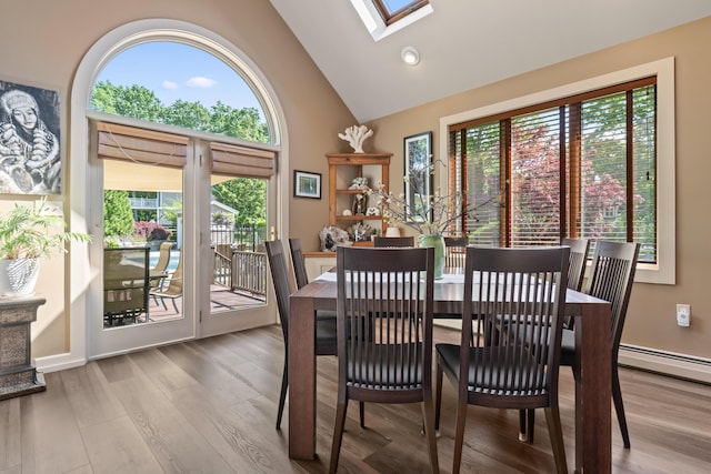 56 Old Kings Hwy, Ogunquit, ME 03907 - dining area with a wealth of natural light, high vaulted ceiling, a skylight, and wood finished floors