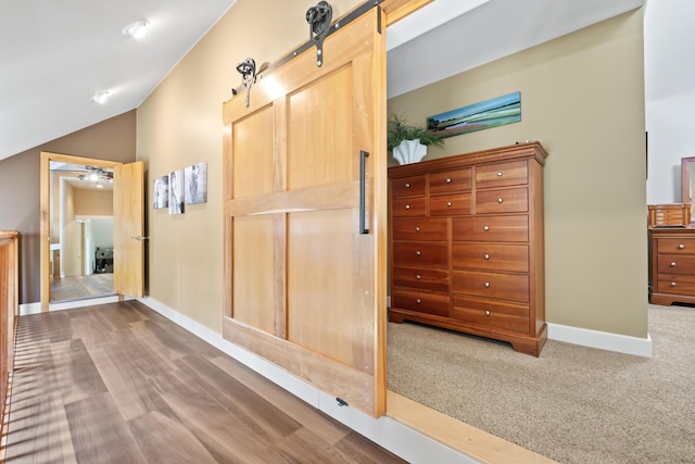 56 Old Kings Hwy, Ogunquit, ME 03907 - hallway with a barn door, baseboards, and lofted ceiling