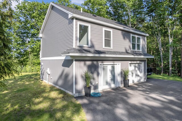 56 Old Kings Hwy, Ogunquit, ME 03907 - view of side of property with driveway, a shingled roof, a lawn, and a garage
