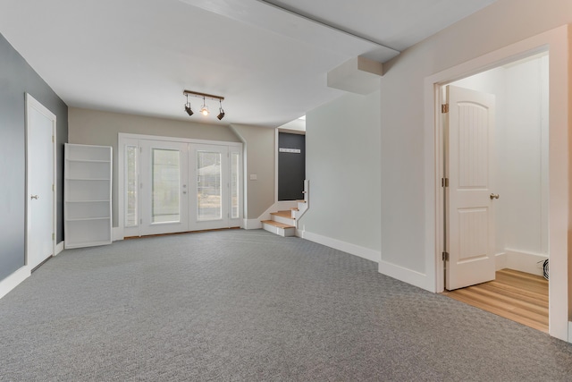 56 Old Kings Hwy, Ogunquit, ME 03907 - unfurnished living room featuring french doors, baseboards, stairway, and carpet floors