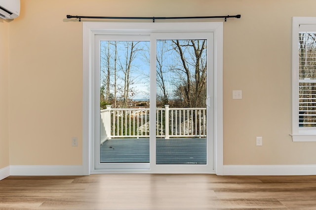 56 Old Kings Hwy, Ogunquit, ME 03907 - entryway featuring an AC wall unit, baseboards, and wood finished floors